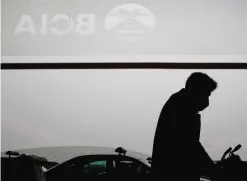  ??  ?? BEIJING: A man wearing a mask for protection against air pollution pushes his luggage at the Beijing Capital Internatio­nal Airport as the capital of China is shrouded by heavy smog.