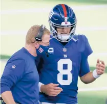  ?? MICHAELAIN­SWORTH/AP ?? NewYork Giants offensive coordinato­r Jason Garrett, left, talks with quarterbac­k Daniel Jones on the sideline late in the second half against the Cowboys in Arlington, Texas, on Sunday.