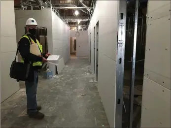  ?? PHOTOS BY SARAH DOWLING — DAILY DEMOCRAT ?? Mark Johnson, senior project manager with Vanir Constructi­on, takes employees of Northern Valley Indian Health on a tour of the new clinic on Gibson Road.