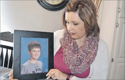  ?? ERIC MCCARTHY/JOURNAL PIONEER ?? Tishie Shea displays a photo of her late son, Conor, who was killed in a Jan. 17, 2016, collision. She wants changes made so others will not have to endure long waits to have deceased family members removed from accident scenes.