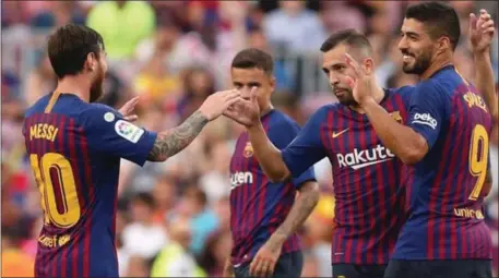  ??  ?? Messi and his Barcelona teammates celebratin­g the win over newcomers Huesca… yesterday