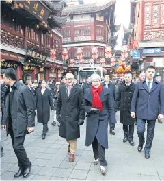  ??  ?? WALKING THE WALK: Theresa May and her husband Philip visit Yu Garden in Shanghai on Friday.