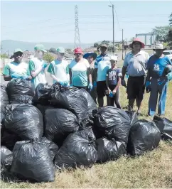  ?? ?? Church members after cleaning-up their area.