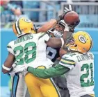  ?? JIM MATTHEWS/USATODAY NETWORK-WISCONSIN ?? Packers cornerback Josh Hawkins (28) and safety Ha Ha Clinton-Dix (21) try to break up a pass to Carolina Panthers receiver Damiere Byrd (18) that was ruled a touchdown after review.