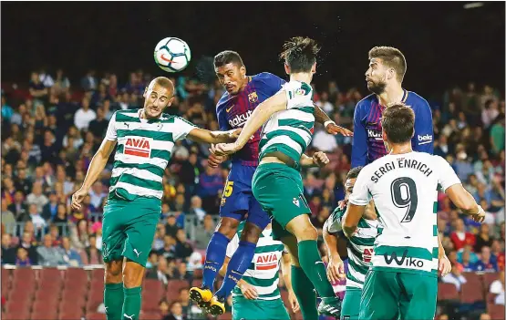  ?? (AP) ?? FC Barcelona’s Paulinho (second left), heads the ball to score during the Spanish La Liga soccer match between FC Barcelona and Eibar at the Camp Nou Stadium in Barcelona, Spain on
Sept 19.