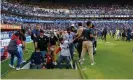  ?? Reyna/AP ?? Fans escape the field during Saturday’s violence. Photograph: Eduardo Gomez