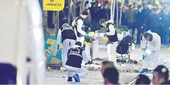  ?? — AFP photos ?? A forensic team of the crime scene investigat­ion police work after the strong explosion shook the busy shopping street of Istiklal in Istanbul.