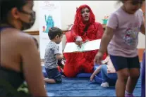  ?? SETH WENIG - THE ASSOCIATED PRESS ?? A drag queen who goes by the name Flame reads stories to children and their caretakers during a Drag Story Hour at a public library in New York, Friday.