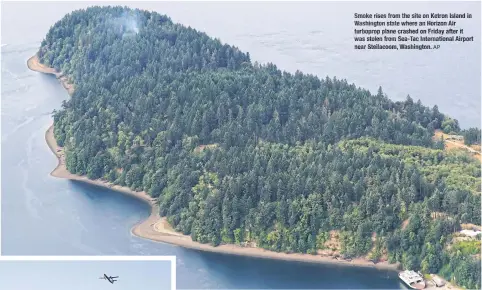  ?? AP ?? Smoke rises from the site on Ketron Island in Washington state where an Horizon Air turboprop plane crashed on Friday after it was stolen from Sea- Tac Internatio­nal Airport near Steilacoom, Washington.