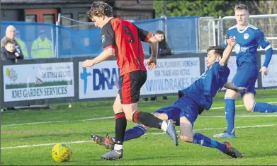  ?? Picture: Chris Davey FM8051523 ?? Hythe stretch to get a tackle in during Saturday’s 3-0 win against Sittingbou­rne
