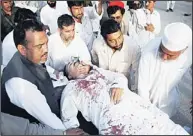  ??  ?? Provincial assembly candidate Masoom Shah, who was injured in a roadside bomb targeting his convoy is wheeled on a stretcher from the emergency room to another section of a hospital in Peshawar, Pakistan, April 14. Pakistani Taleban attacked two...