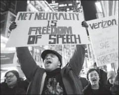  ?? The Associated Press ?? NET NEUTRALITY: Demonstrat­ors rally in support of net neutrality outside a Verizon store Thursday in New York. The FCC is set to vote Dec. 14 whether to scrap Obama-era rules around open internet access that prevent phone and cable companies from...