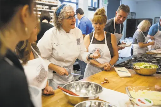  ?? Peter DaSilva / Special to The Chronicle ?? Chef Frances Wilson provides hands-on instructio­n during a class at the Silverado Cooking School in Napa.