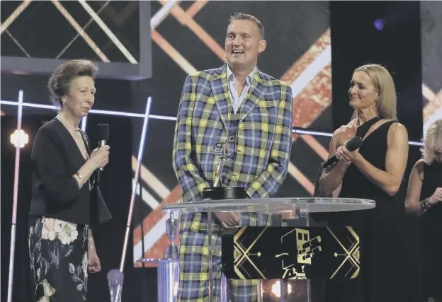  ??  ?? 0 A delighted Doddie Weir receives the Helen Rollason Award from the Princess Royal during the BBC Sports Personalit­y of the Year 2019 in Aberdeen yesterday