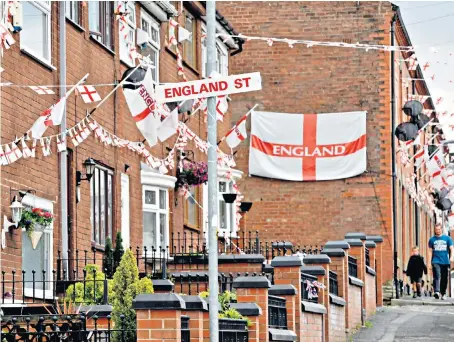  ??  ?? Wales Street in Oldham has been given a patriotic makeover and temporaril­y renamed “England Street” by residents in preparatio­n for the national team’s first World Cup group match against Tunisia on Monday.