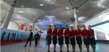  ??  ?? Cabin crew from Turkish Airlines at the new terminals, which opened last Monday