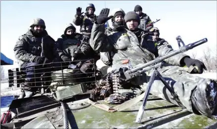  ?? ANATOLII STEPANOV/AFP ?? Ukrainian soldiers riding a tank arrive near Artemivsk after leaving the eastern Ukrainian city of Debaltseve in the Donetsk region on February 18, 2015.