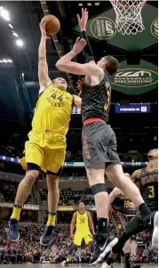 ?? AP ?? Indiana Pacers’ Bojan Bogdanovic ( left) shoots over Mike Muscala of the Atlanta Hawks in their NBA game in Indianapol­is on Friday. The Pacers won 112- 87.