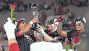  ?? ADAM CAIRNS/COLUMBUS DISPATCH ?? Ohio State quarterbac­k C.J. Stroud, linebacker Tommy Eichenberg and receiver Jaxon Smith-njigba celebrate following their win over Utah in the Rose Bowl on Jan. 1.