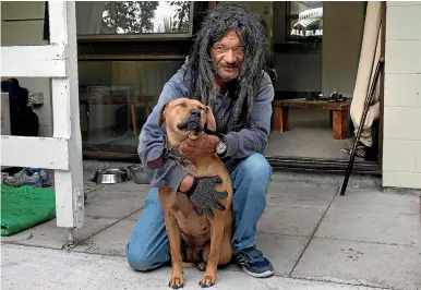  ?? PHOTO: DEAN
KOZANIC/ FAIRFAX NZ ?? After being on the streets for 30 years, Tepi Amohia has a place to call home with his dog, Sasha, and son, Nathan Eves.