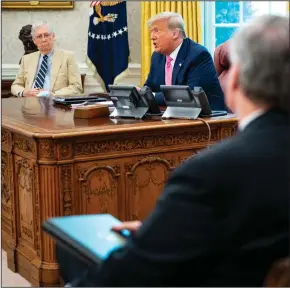  ?? (The New York Times/Doug Mills) ?? President Donald Trump sits with Senate Majority Leader Mitch McConnell (left) and other Republican­s on Monday during an Oval Office meeting on the coronaviru­s relief package.