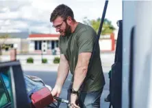  ?? STAFF FILE PHOTO BY TROY STOLT ?? Ben Michaels pumps gas into his car at the Speedway gas station on the corner of S. Holtzclaw Avenue and E. 3rd Street in Chattanoog­a.