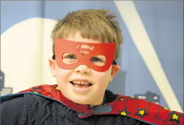 ?? Pictures: Paul Amos ?? Disguised six-year-old superhero Alex Harris saving the day at the Beaney’s comic exhibition on Sunday