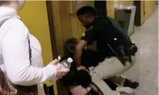  ?? KATC-TV/THE ASSOCIATED PRESS ?? Deyshia Hargrave is handcuffed by a city marshal after complying with a marshal’s orders to leave a Vermilion Parish School Board meeting.