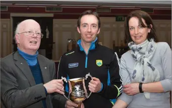  ??  ?? Kerry Badminton chairman Junior Griffin, on the left, presenting the Billy Lacey Peputual Cup to Billy Lacey, along with Brid Murphy, Secretary of Kerry Badminton, at the launch in Castleisla­nd last week.