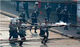  ?? MYAT THU KYAW/NURPHOTO/REX ?? Violence:
Police tackle protesters in Yangon on Sunday