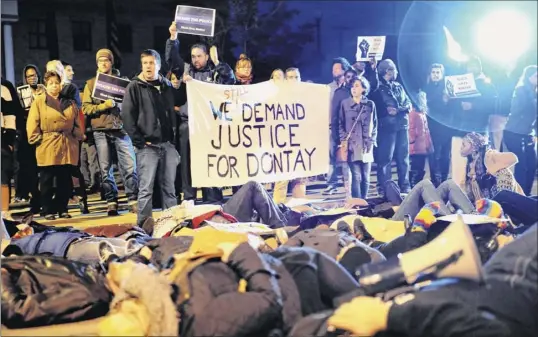  ?? Cindy Schultz / times union archive ?? Protesters lie down and block traffic oct. 30, 2015, on Henry Johnson Boulevard in front of the Albany Police department headquarte­rs. Social justice advocates and the community protested a grand jury’s decision not to charge police who confronted and struggled with donald “dontay” ivy on the night he died.