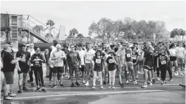  ?? ?? Runners wait for the start of the 5k race during the Dolphins Challenge Cancer XIV at Hard Rock Stadium. The DCC unites the community with 100 percent of funds raised going toward life-saving cancer research at Sylvester Comprehens­ive Cancer Center.