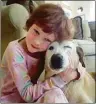  ?? Jenny Hubbard / Associated Press ?? Catherine Hubbard hugs her family’s dog, Sammy, at their home in Newtown in April 2012.