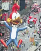  ??  ?? Woody Woodpecker leads a line of other balloons and floats into New York’s Times Square during the 69th annual Macy’s Thanksgivi­ng Day parade.