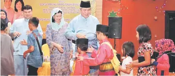  ??  ?? Awang Tengah and his wife Dayang Morliah welcoming guests to their Raya open house.