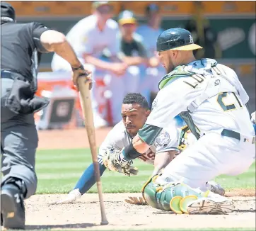  ?? DOUG DURAN — STAFF PHOTOGRAPH­ER ?? A’s catcher Jonathan Lucroy attempts the late tag as the Astros’ Tony Kemp slides into home plate safe on Thursday.
