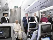  ?? AP ?? The Archbishop of Canterbury Justin Welby (right), Pope Francis (left), and the Moderator of the General Assembly of the Church of Scotland Iain Greenshiel­ds meet with journalist­s aboard a plane headed to Rome Sunday.