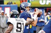  ?? GETTY IMAGES ?? Giants quarterbac­k Eli Manning tries to elude Jaguars rusher Yannick Ngakoue in Week 1. The Giants travel to Dallas to play the Cowboys on Sunday night.