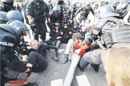  ?? Picture: Reuters ?? ALL FALL DOWN. German police remove protesters blocking a street at a demonstrat­ion during the G20 summit in Hamburg yesterday.