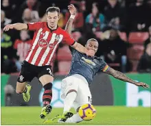  ?? KIRSTY WIGGLESWOR­TH THE ASSOCIATED PRESS ?? Southampto­n’s Cedric Soares, left, competes for the ball with Man U’s Ashley Young . The teams played to a 2-2 soccer draw.