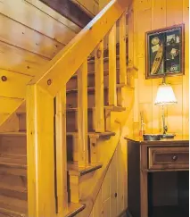  ??  ?? Vertical and horizontal wall panelling in the entryway contrast nicely with the pinewood stairs, which lead to the guest room on the second floor.