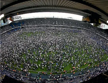  ?? PHOTO: GETTY IMAGES ?? Tottenham Hotspur fans invade the pitch after their win over Manchester United, the final match at White Hart Lane after 118 years at the stadium.