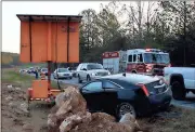  ?? Doug Walker / RN-T ?? Traffic on Ga. 140 is down to one lane Friday morning after a wreck which involved the Cadillac shown in the foreground.