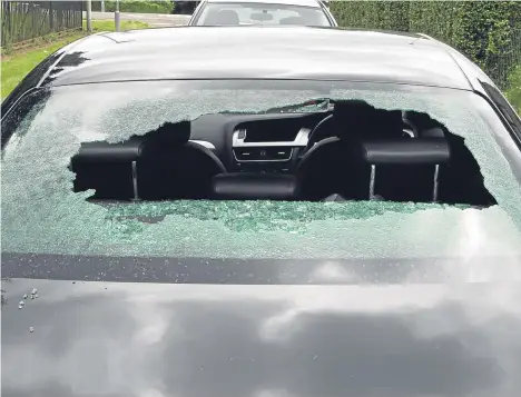  ??  ?? The smashed back window of the black Audi, which was targeted by a vandal. Pictured below, a punctured tyre.