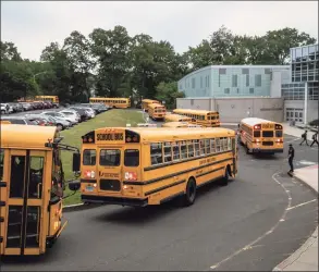  ?? John Moore / Getty Images ?? Buses drop off students at Rippowam Middle School on Monday in Stamford.