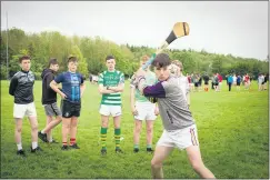  ?? ?? Students line up for the long puck event, as Ciarán Leamy strikes for glory.