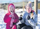  ??  ?? ●● Amelia Taylor and Abigail O’Toole enjoying toasted marshmallo­ws