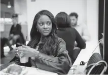  ?? MAANSI SRIVASTAVA NYT ?? Charity Lawson grabs a drink before heading to a bridal dress presentati­on by designer Nardos Imam in Manhattan, on April 3. Lawson, who met her fiancé on the most recent season of “The Bacheloret­te,” prepared for her nuptials at New York Bridal Fashion Week.