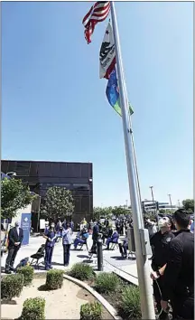  ??  ?? In observance of National Donate Life Month, Kern Medical staff stand at attention during a flag-raising ceremony outside the hospital on Wednesday.