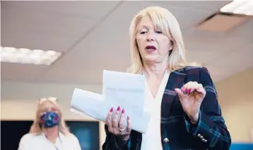  ?? MCKENZIE LANGE/THE GRAND JUNCTION DAILY SENTINEL 2020 ?? Mesa County Clerk Tina Peters reads an update on an election in Colorado. A grand jury is investigat­ing whether Peters facilitate­d a security breach of election equipment.